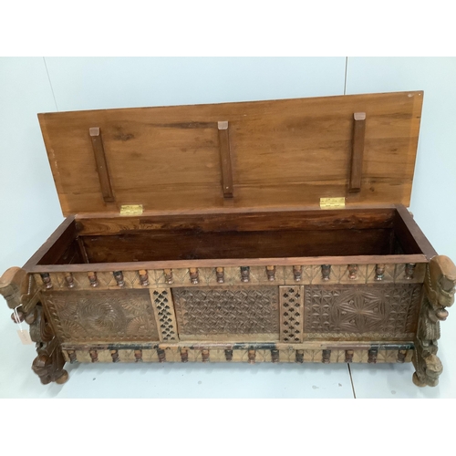 123 - An Indian carved and panelled hardwood low chest, with figural motifs, width 148cm, depth 60cm, heig... 