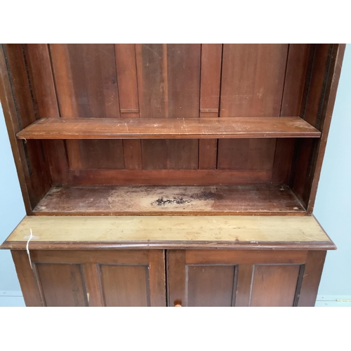 124 - A Victorian mahogany bookcase cupboard, width 127cm, depth 47cm, height 221cm