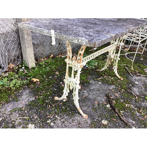 191 - A Victorian cast iron table garden table with weathered marble top, width 139cm, height 71cm