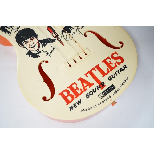 251 - The Beatles plastic toy guitar by Selcol, 59cm