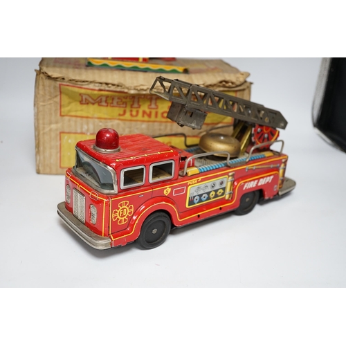 276 - Four tinplate toys; a model of a 1920s taxi, a 1960s German made fire engine, an automaton clown, an... 