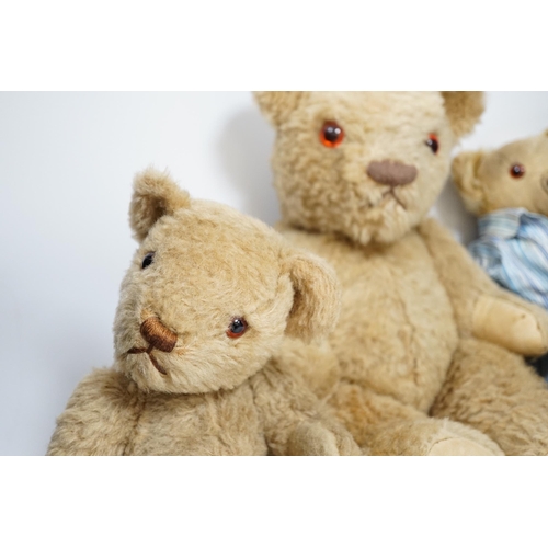 305 - Two Invicta bears, 30cm and 45cm, some wear, and a Merrythought bear, dressed in vintage dressing go... 