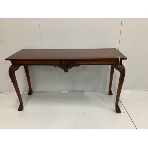 33 - A reproduction George III style mahogany console table, with carved frieze, on cabriole legs, length... 