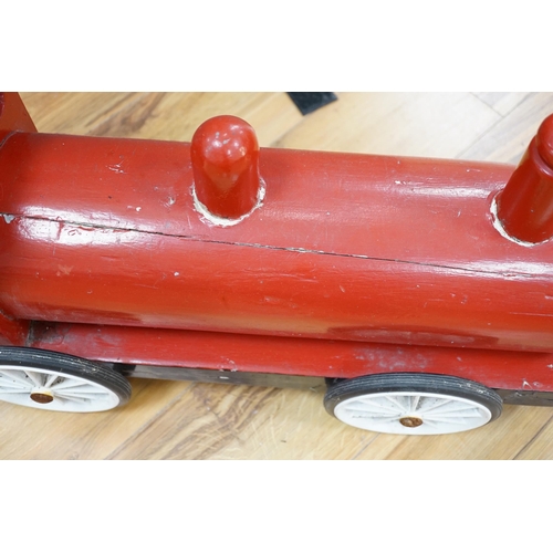 338 - A painted wood pull along locomotive, 96cm