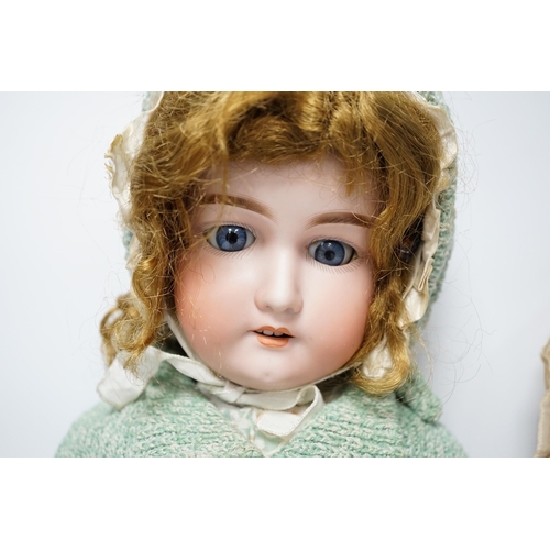 354 - An AM390 bisque head doll, 63cm good condition, and an AM390, missing two fingers and wear on other ... 