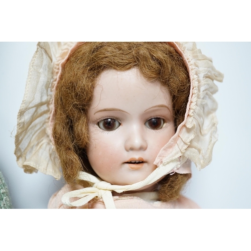 354 - An AM390 bisque head doll, 63cm good condition, and an AM390, missing two fingers and wear on other ... 