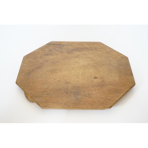 384 - A Robert Mouseman Kilburn octagonal carved oak breadboard, 30x25cm