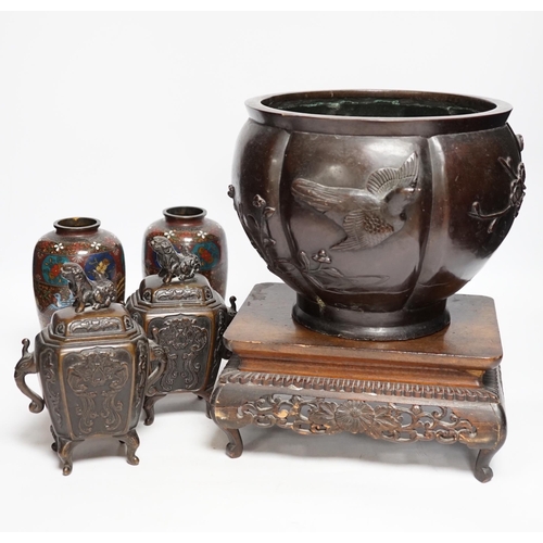 404 - A Meiji period Japanese bronze jardiniere, a pair of cloisonné vases, a hardwood stand, etc.