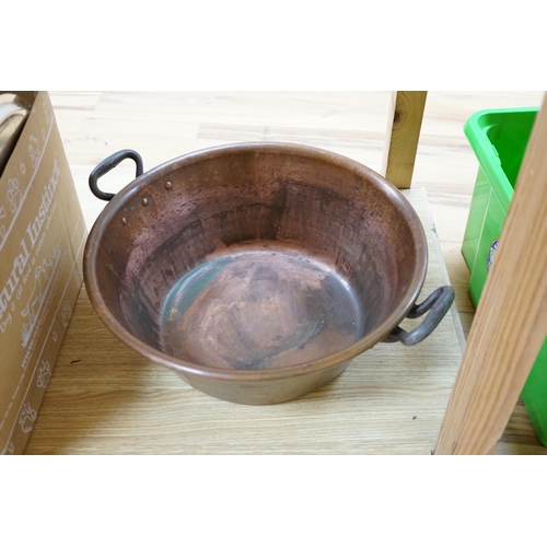 417 - A copper two handled jam pan and a graduated set of eight copper saucepans