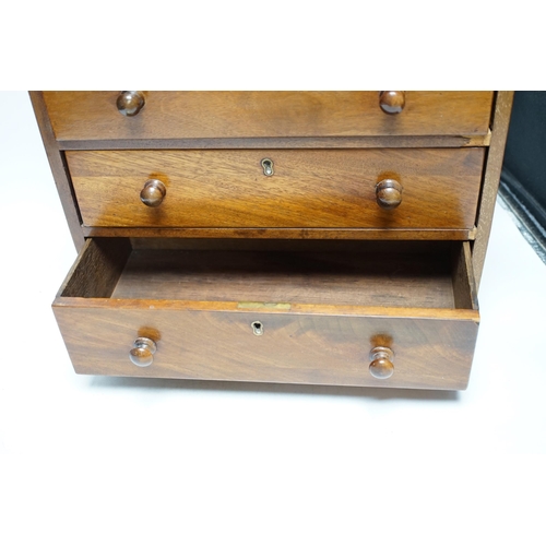 474 - A Victorian mahogany miniature four draw chest, an amboyna glove box and a games box