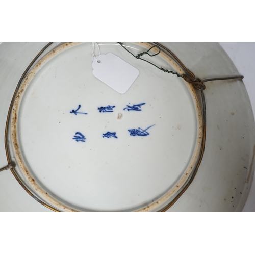 478 - A 19th century Japanese dish, painted with peonies, within a square, 40cms. dia.