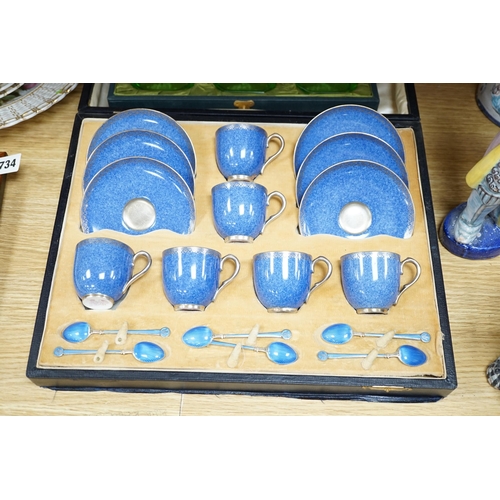 484 - A cased Worcester powder blue and silvered coffee set with enamelled silver spoons together with a c... 