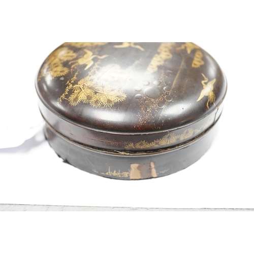 544 - A Japanese cast mirror, housed in a lacquered case, 12cm in diameter