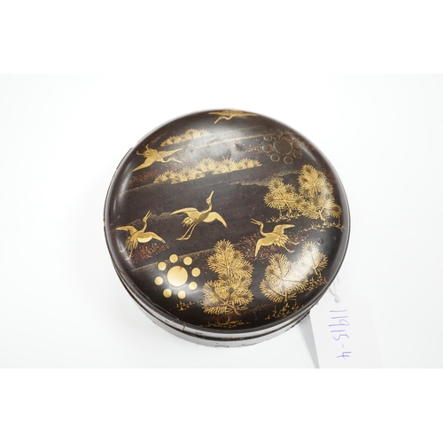 544 - A Japanese cast mirror, housed in a lacquered case, 12cm in diameter