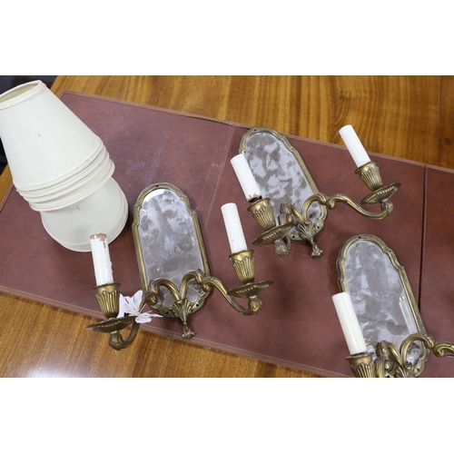 556 - A set of four twin-branch mirror-backed wall sconces, 30cm high