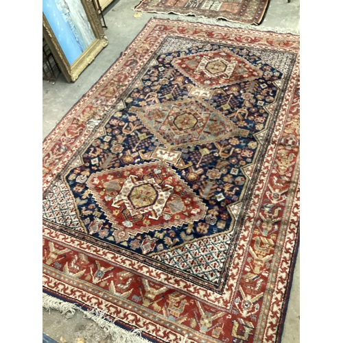 56 - A Caucasian blue ground carpet (holed), 300 x 198cm