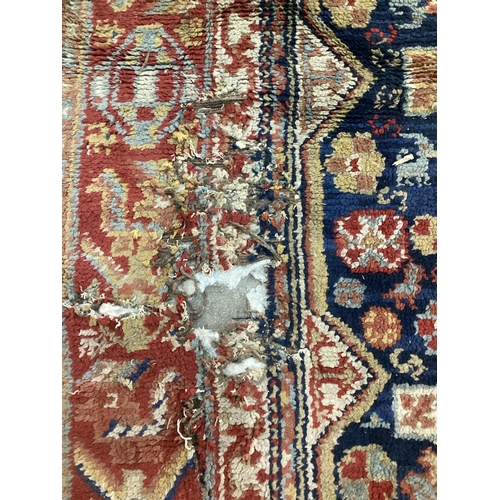 56 - A Caucasian blue ground carpet (holed), 300 x 198cm