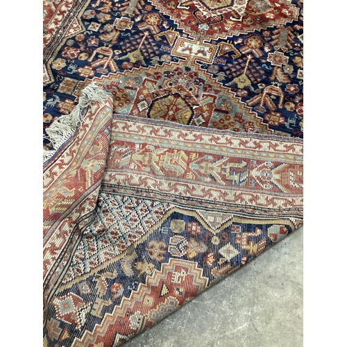 56 - A Caucasian blue ground carpet (holed), 300 x 198cm