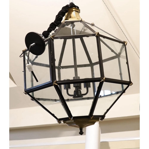 560 - A pair of contemporary bronzed and black painted octagonal lanterns, 64cm wide, 90cm high