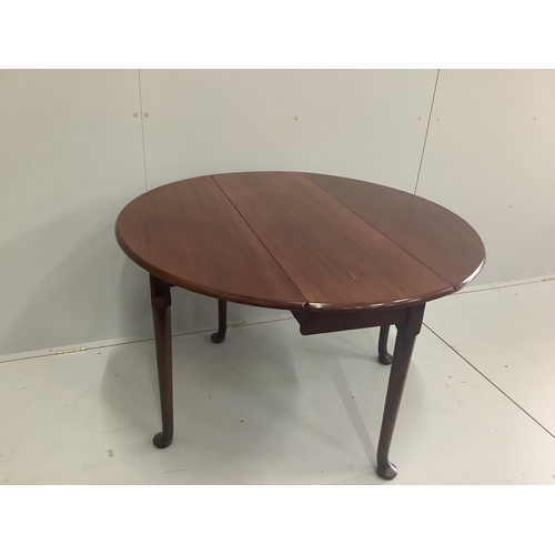 57 - A George III mahogany oval pad foot drop leaf dining table, width 106cm, depth 110cm extended, heigh... 