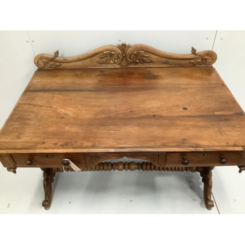 62 - An Anglo-Indian carved hardwood writing table, two frieze drawers, on scrolled end supports, width 1... 