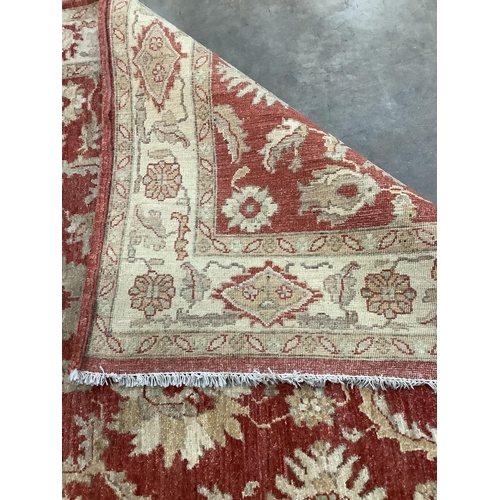 68 - A Ziegler style burgundy ground rug, 220 x 150cm