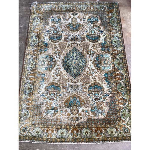 77 - ** ** A Tabriz silk rug, woven with floral bouquets about a central medallion, 154 x 111cms Please n... 