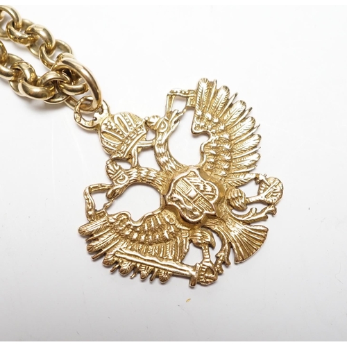 934 - An Austrian yellow metal double eagle pendant, width 31mm, on a 9ct gold belcher link chain, 62cm, g... 