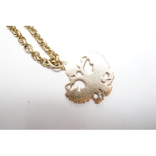 934 - An Austrian yellow metal double eagle pendant, width 31mm, on a 9ct gold belcher link chain, 62cm, g... 