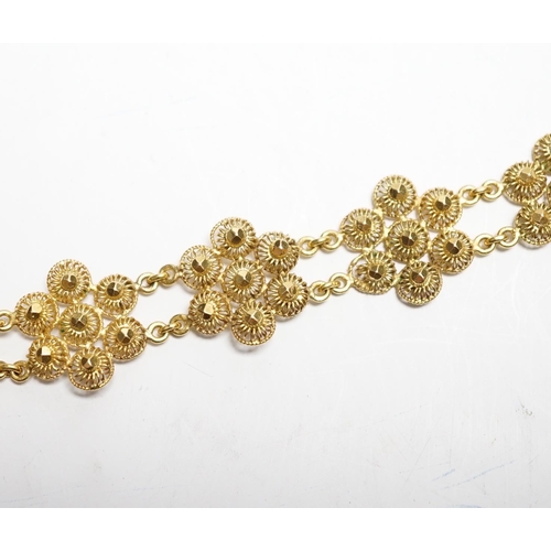 937 - A yellow metal 'bright cut engraved' flower head link bracelet, 16cm, 14.7 grams.
