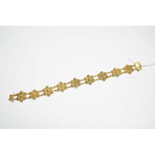 937 - A yellow metal 'bright cut engraved' flower head link bracelet, 16cm, 14.7 grams.
