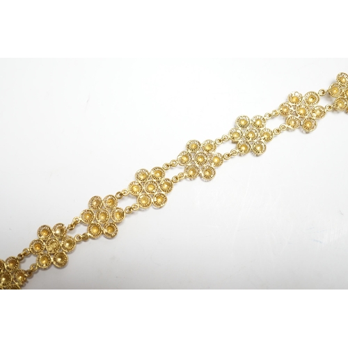937 - A yellow metal 'bright cut engraved' flower head link bracelet, 16cm, 14.7 grams.