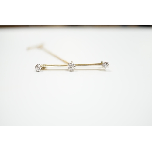 939 - A yellow metal and three stone diamond set bar brooch, 37mm, with safety chain, gross weight 3 grams... 