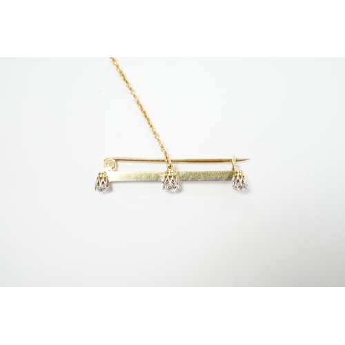 939 - A yellow metal and three stone diamond set bar brooch, 37mm, with safety chain, gross weight 3 grams... 