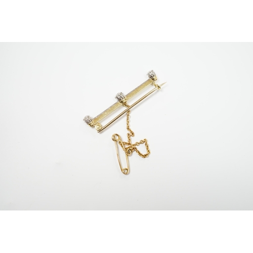 939 - A yellow metal and three stone diamond set bar brooch, 37mm, with safety chain, gross weight 3 grams... 