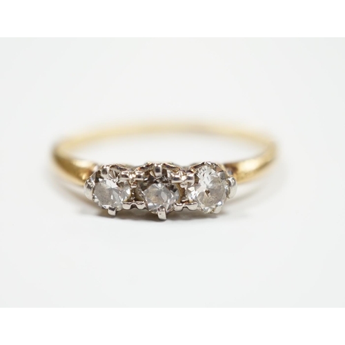 940 - A yellow metal and three stone diamond set ring, size M, gross weight 2.3 grams.