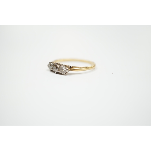 940 - A yellow metal and three stone diamond set ring, size M, gross weight 2.3 grams.