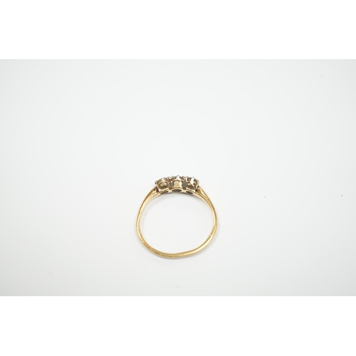 940 - A yellow metal and three stone diamond set ring, size M, gross weight 2.3 grams.