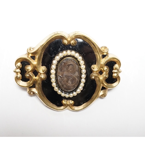 953 - A Victorian yellow metal, black enamel and seed pearl set mourning brooch, 47mm.