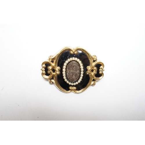 953 - A Victorian yellow metal, black enamel and seed pearl set mourning brooch, 47mm.