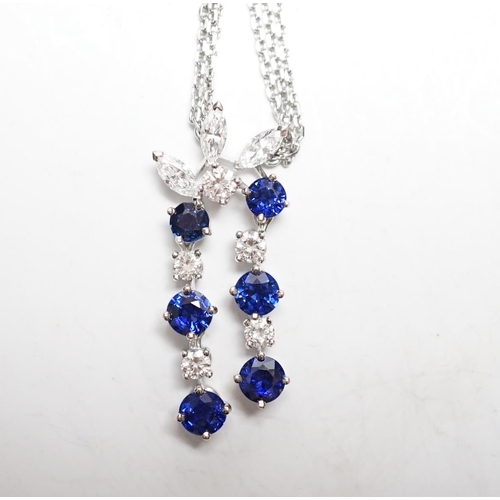 955 - A modern 750 white metal, sapphire and diamond set cluster pendant, 31mm, on a twin strand white met... 