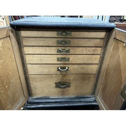 96 - An Edwardian ebonised oak canteen cabinet on associated stand, width 64cm, depth 49cm, height 113cm... 