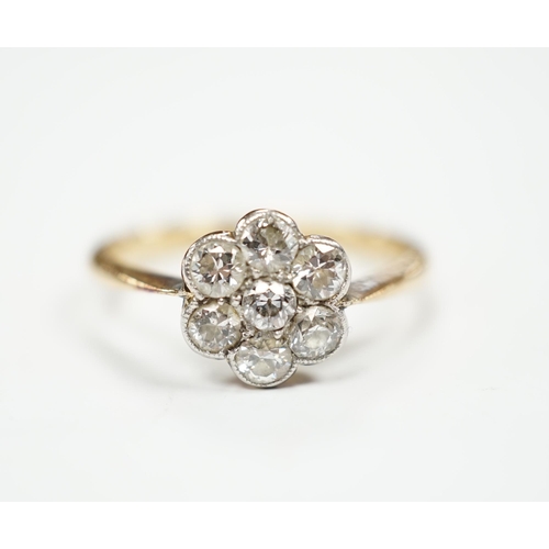 969 - An 18ct and seven stone diamond set flower head cluster ring, size M/N, gross weight 2.9 grams.... 