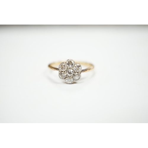 969 - An 18ct and seven stone diamond set flower head cluster ring, size M/N, gross weight 2.9 grams.... 