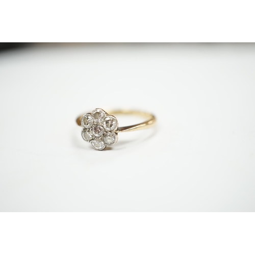 969 - An 18ct and seven stone diamond set flower head cluster ring, size M/N, gross weight 2.9 grams.... 