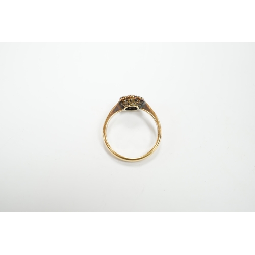 969 - An 18ct and seven stone diamond set flower head cluster ring, size M/N, gross weight 2.9 grams.... 