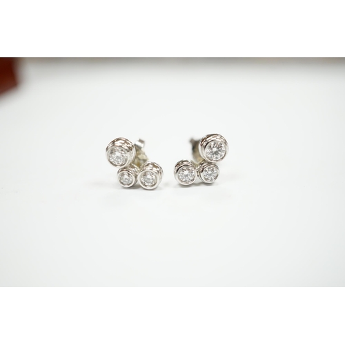 972 - A modern pair of Tiffany & Co platinum and three stone graduated diamond set ear studs, 10mm, gross ... 