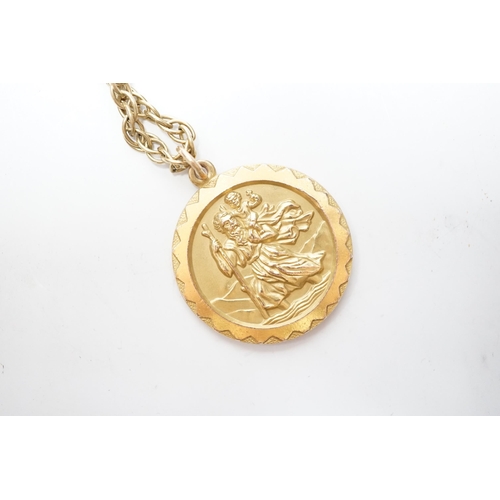 973 - A 1970's 9ct gold St. Christopher's pendant, 27mm, on a 9ct chain, 65cm, 22.6 grams.
