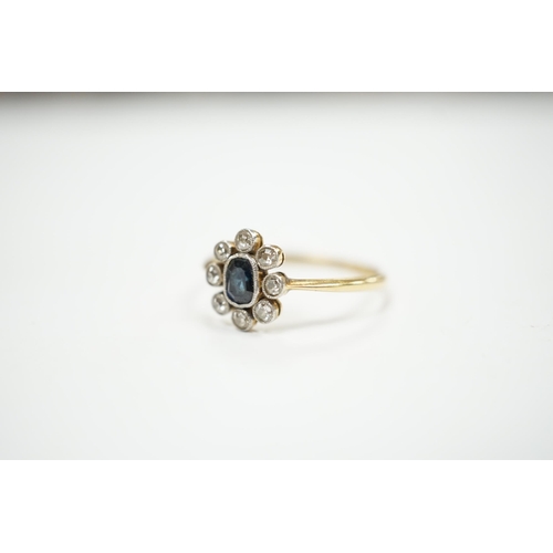 975 - An 18ct, sapphire and diamond cluster set oval ring, size M, gross weight 2 grams.