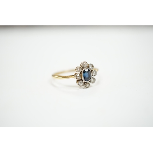 975 - An 18ct, sapphire and diamond cluster set oval ring, size M, gross weight 2 grams.